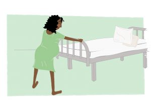 Image of Woman leaning against the bed whilst giving birth - copyright New Life Classes